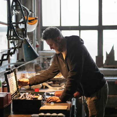 Man looking into an open tool box on a workbench